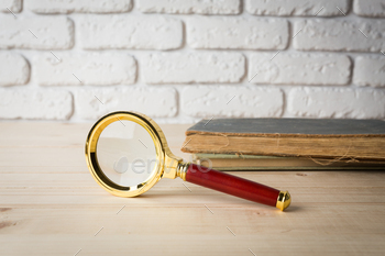 Magnifying glass and book