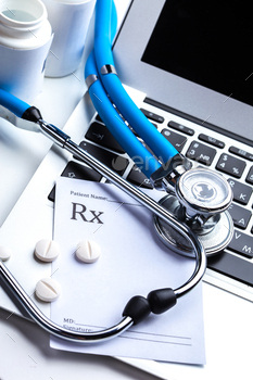 Medical stethoscope on computer keyboard