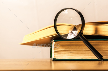 books and magnifying glass
