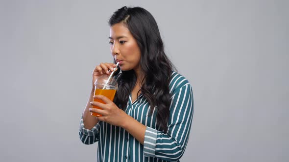 Woman Drinking Juice From Plastic Cup with Straw