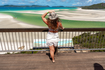 A woman stands on a wooden platform overlooking a withheaven