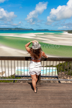 A woman stands on a wooden platform overlooking a withheaven