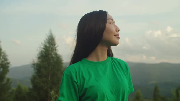 Portrait of Charming Asian Woman Enjoying Fresh Mountain Air and Beautiful Nature at Sundown