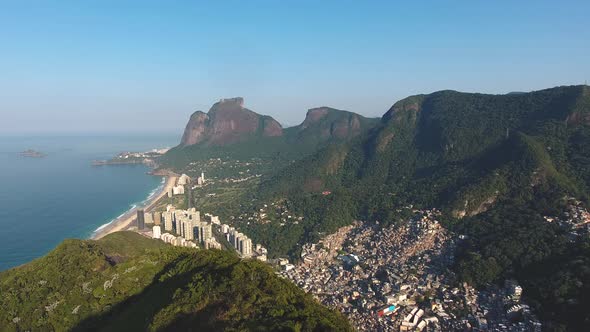 Aerial Drone Shot Over a Mountain Ridge Revealing a City on the Coast of Rio De Janeiro Brazil