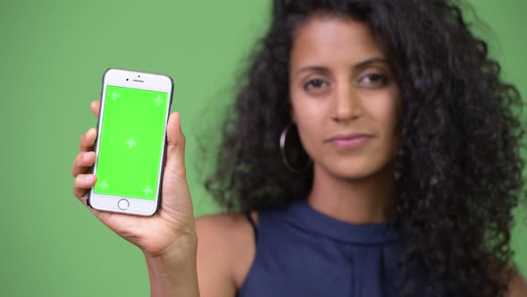 Young Beautiful Hispanic Businesswoman Showing Phone