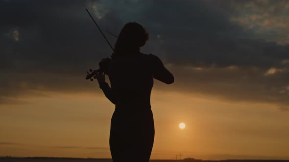 Female Silhouette of Musician From the Back