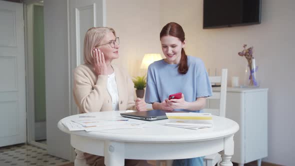 Elderly Woman Listens to Music Using Wireless Headphones