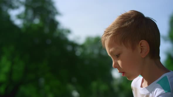 Concentrated Boy Play Football Closeup