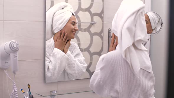 Cheerful Woman Looking at Her Skin