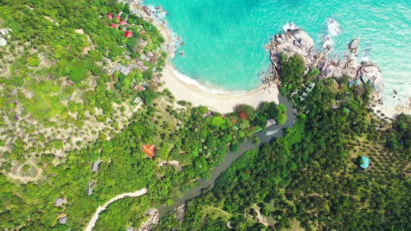 Luxury above abstract view of a white sand paradise beach and blue water background in vibrant 4K