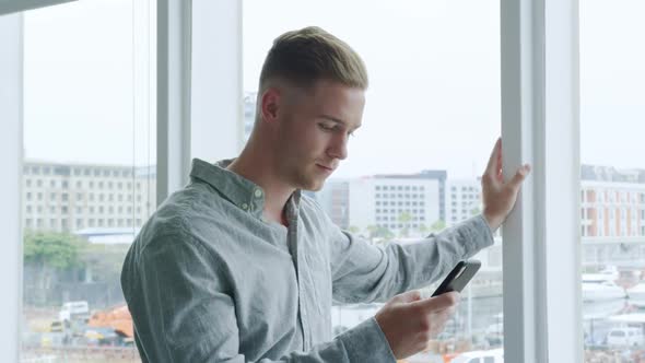 Man using smartphone in a modern office