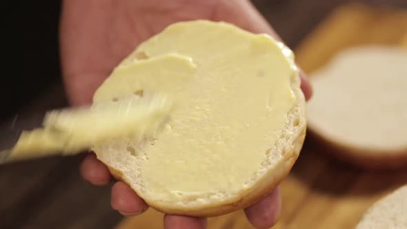 Putting Butter On Round Cut Buns - Close Up - Top Angle