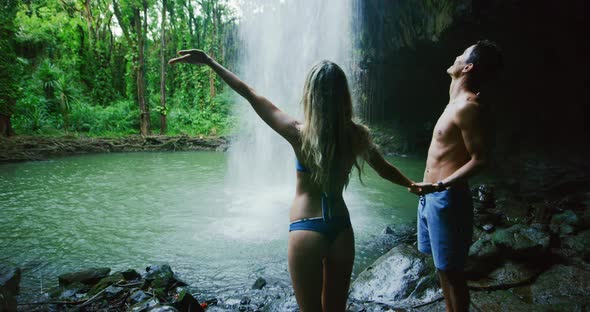 Couple Exploring Jungle Waterfall