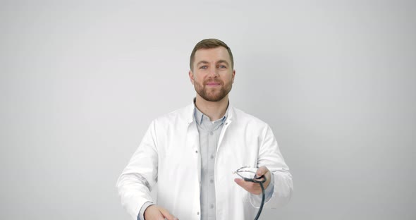 Young European Doctor Putting on Stethoscope