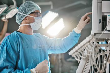 Surgery, machine and doctor with monitor in hospital for healthcare, theatre operation or analysis.