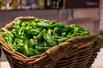 a basket of green peppers with a basket of green peppers.