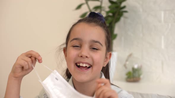 Little Girl Takes Off Her Protective Medical Mask and Smiles