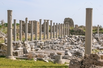 Ruins of an ancient Greek temple with columns and a stone platform.