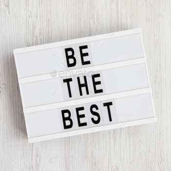 Lightbox with 'Be the best' words on a white wooden background.