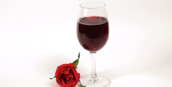 Pouring Red Wine with a Rose