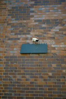 CCTV security camera operating on a wall