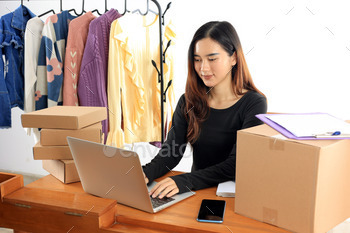 Asian Female Fashion Online Shop Seller Working on Laptop