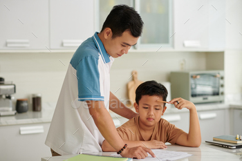 School boy Asking Father to Help with Homework