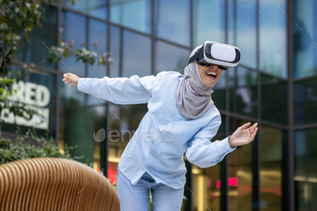 Joyful woman experiencing virtual reality outdoors