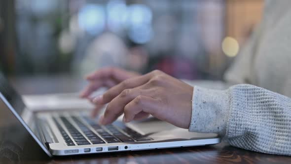 Side View of African Woman Typing on Laptop