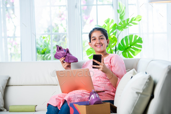 Indian young girl online shopping or returning shoes