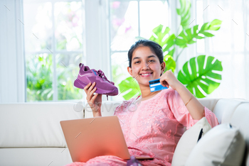 Indian young girl online shopping or returning shoes