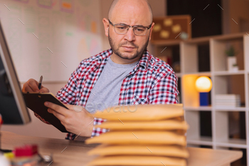 Entrepreneur getting online store orders ready for shipping