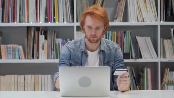 Online Shopping By Redhead Man in Office