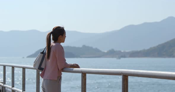 Woman look at the sea at countryside 