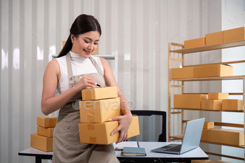 Woman asian in an online store check the customer address and package information on the laptop