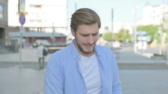 Portrait of Disappointed Man Reacting to Loss Outdoor