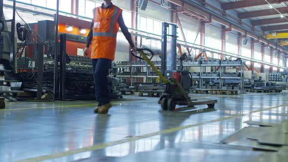 Female Factory Worker Walking with Hand Truck