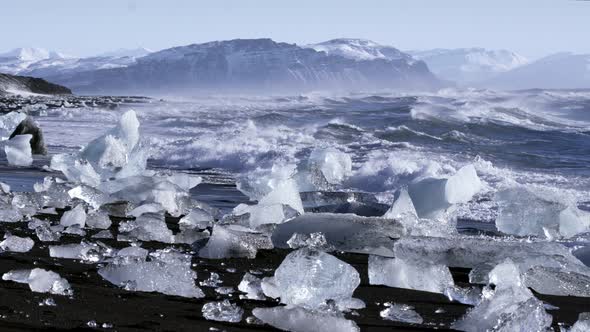 Ice From a Glacier Washing By Atlantic Ocean Waves on a Black Diamond Beach in Iceland. Climate