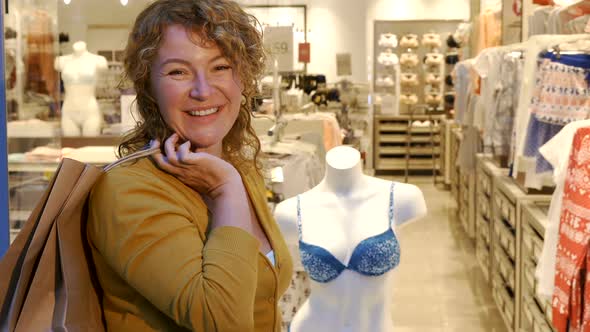 Woman Holds Shopping Bag on Her Shoulder