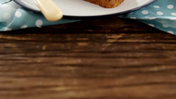 Sliced bananas spread on brown bread in plate