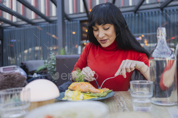 Woman Enjoying a Gourmet Salmon Meal Outdoors
