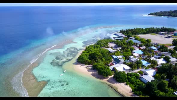 Aerial seascape of idyllic resort beach holiday by blue ocean with white sand background of adventur