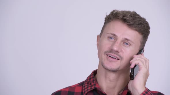 Face of Happy Bearded Hipster Man Talking on the Phone