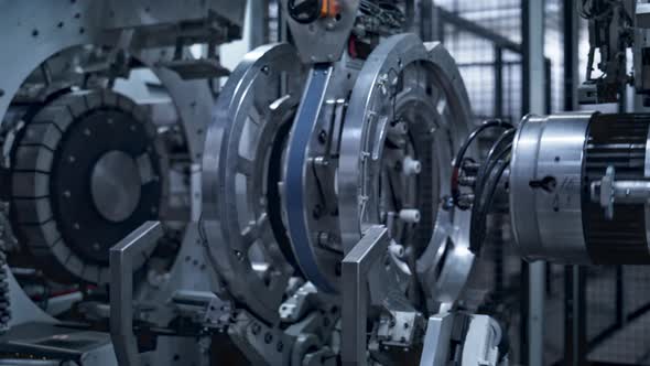 Robotic Tyre Manufacturing Equipment Rotating with Rubber Tape at Auto Plant