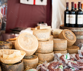 Cheeses and cut pieces on sale at market.