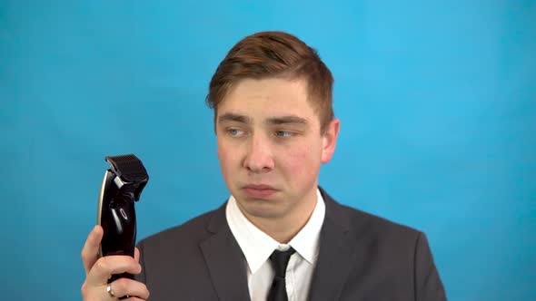 Businessman with a Hairdresser. A Man in a Suit on a Blue Background Is Preparing for a Haircut.