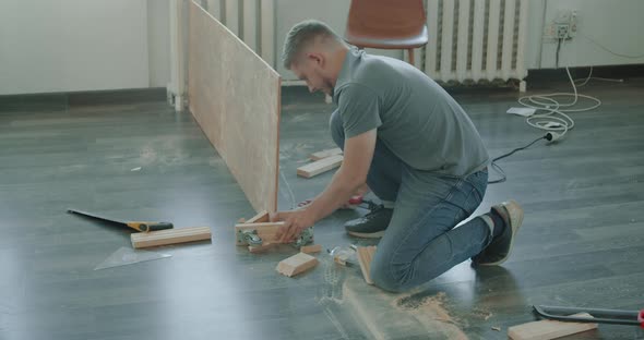 Man is Building Furniture Himself Making Renovation at Home