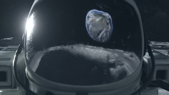 An Astronaut Stands on the Surface of the Moon Among Craters Against the Backdrop of the Planet