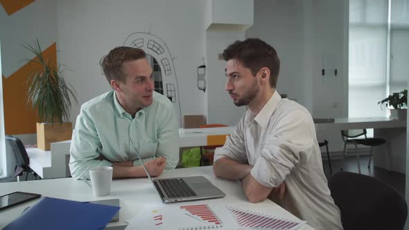 Two Handsome Men Have Friendly Conversation at Creative Hipster Office