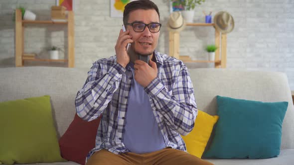 Portrait of Middle-aged Man Answering a Phone Call Uses Speech Aid Problems with Ligaments